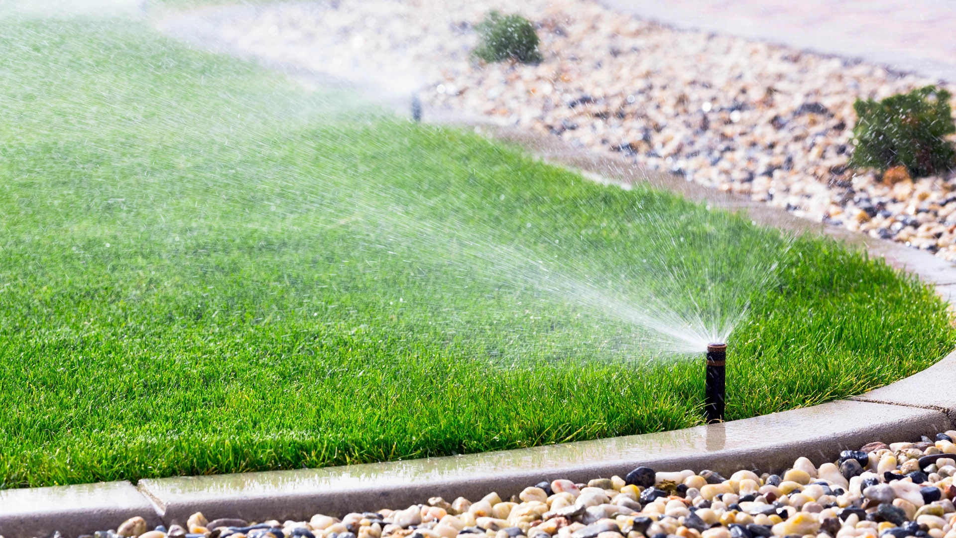 Jackson, MS home with new irrigation watering the lawn.