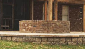 Custom brick fire pit by Ambiance Landscape for residential property in Jackson, MS.