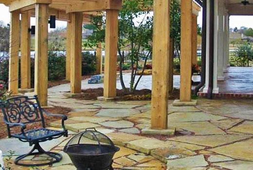 Custom stone patio hardscaping by Ambiance Landscape in Jackson, MS.