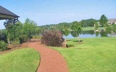 Residential home in Jackson, MS with lawn mowing service by Ambiance Landscape.
