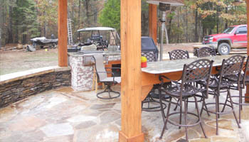 Custom outdoor kitchen with gas grill at home in Jackson, MS, by Ambiance Landscape.