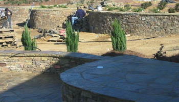 Stone landscape retaining wall at home in Jackson, MS being installed by Ambiance Landscape.